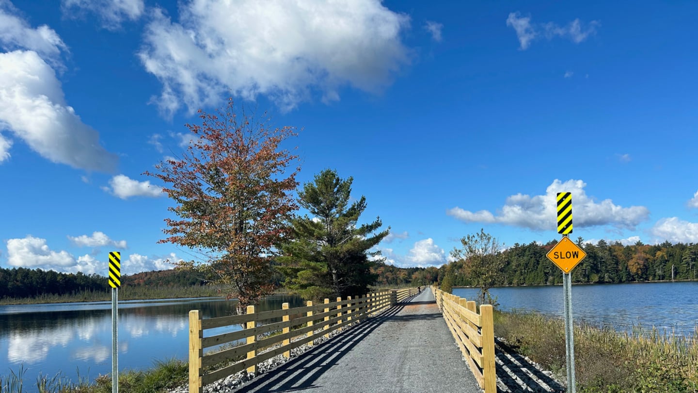 The recently opened section of the Adirondack Rail Trail offers good signage, wooden railings where needed, and a stone-dust surface. Come winter, snow machines and Nordic skiers will give it a go.