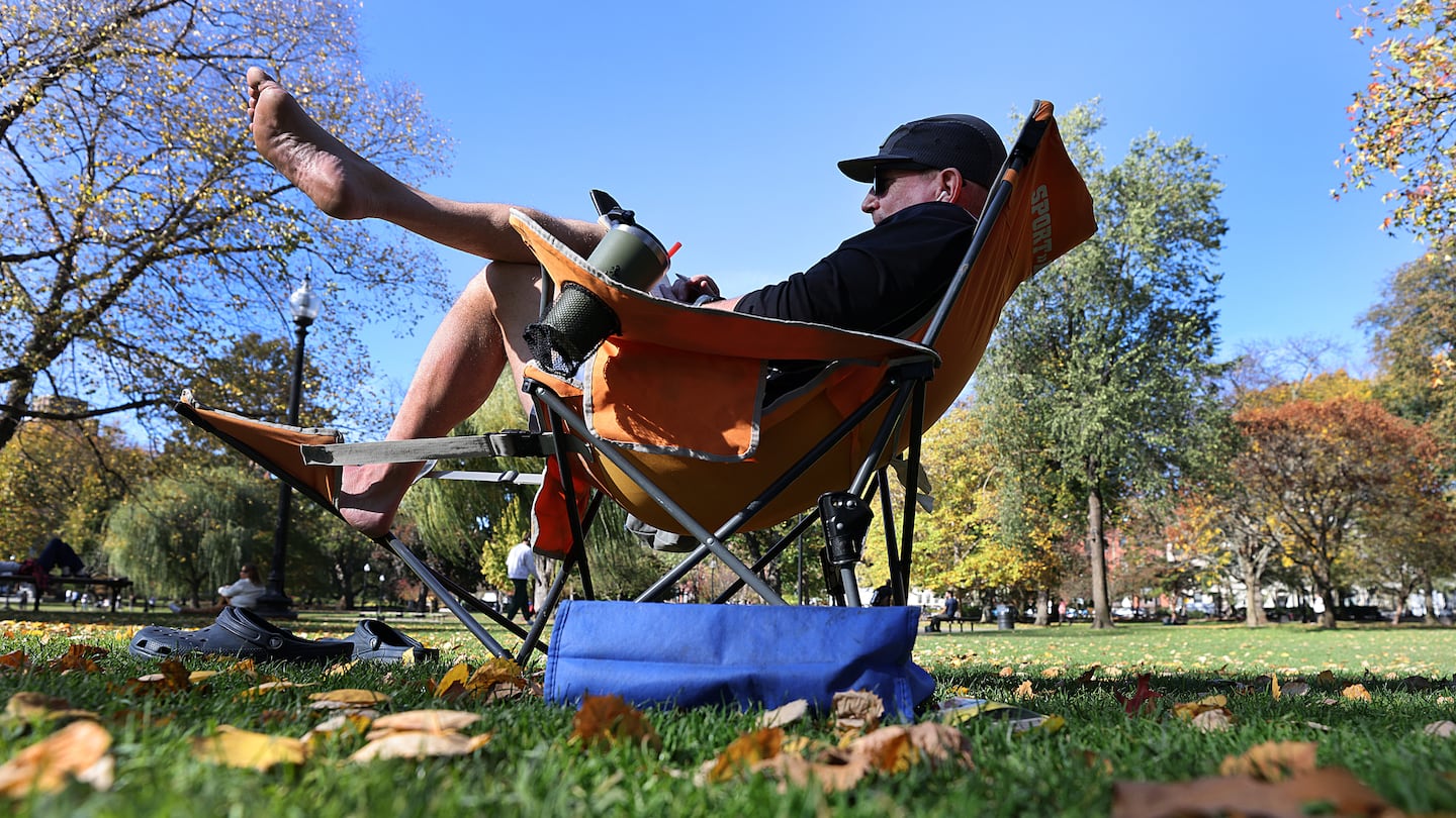 The exceptionally warm temperatures on Wednesday had already broken records for Boston and other locations across New England shortly before noon. Above, Brian Coey brought a lounge chair to enjoy the record-setting warmth at the Public Garden on Wednesday.