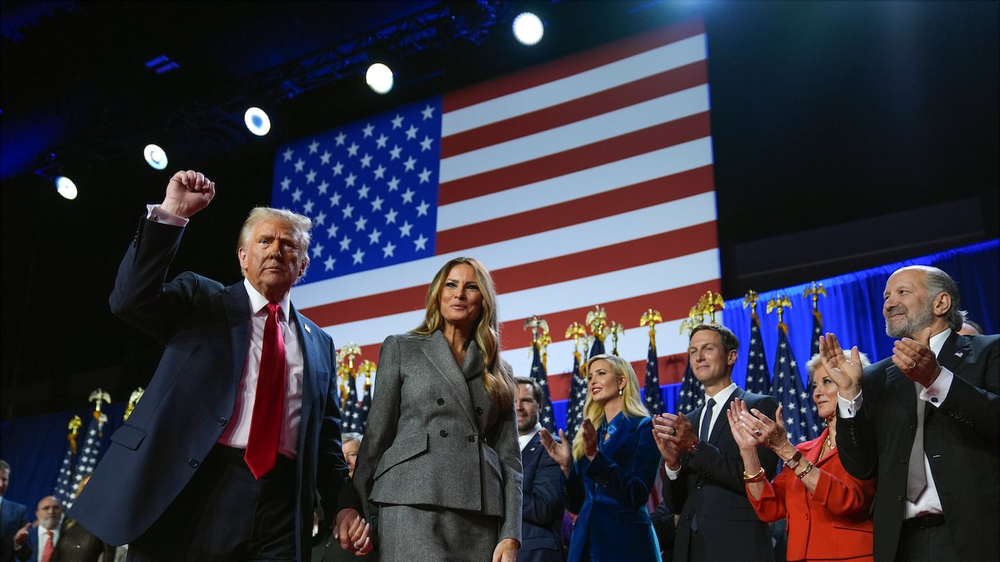 President-elect Donald Trump gestures as he walks with former first lady Melania Trump at an election night watch party at the Palm Beach Convention Center, Wednesday, Nov. 6, 2024, in West Palm Beach, Fla.