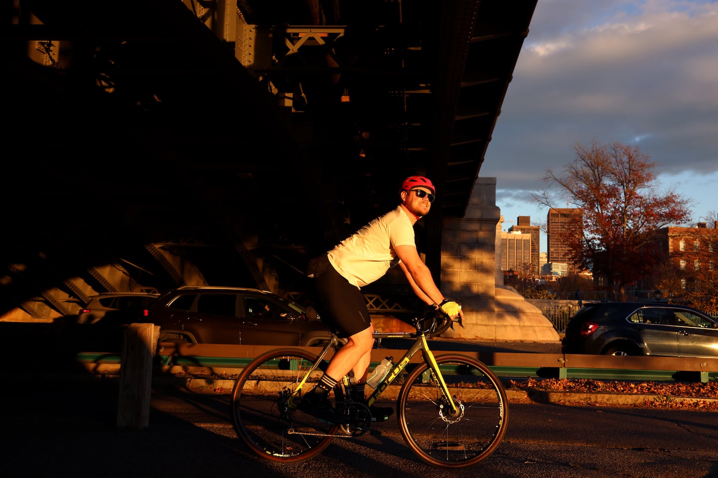 A bicyclist looks out at the Charles River after passing underneath the Longfellow Bridge at sunset on Thursday.