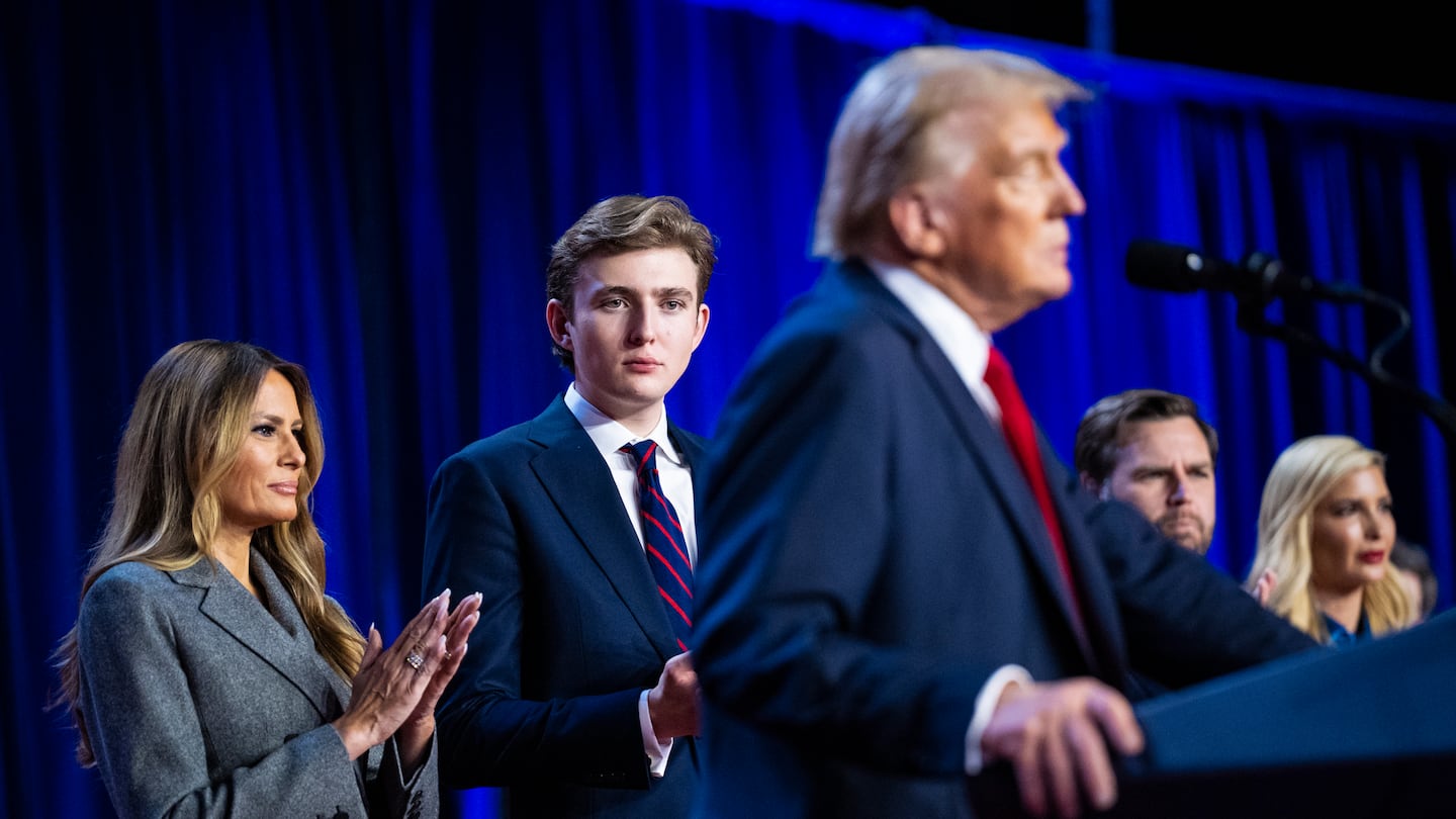 Melania Trump and Barron Trump listen as Donald Trump walks onstage to declare victory on Wednesday.