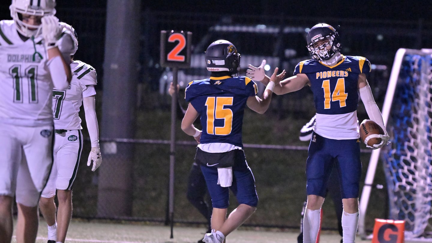 Lynnfield quarterback Tyler Adamo (15) and Madux Iovinelli (14) teamed up for a number of explosive plays in the Pioneers' 45-20 win over Dennis-Yarmouth Friday night.