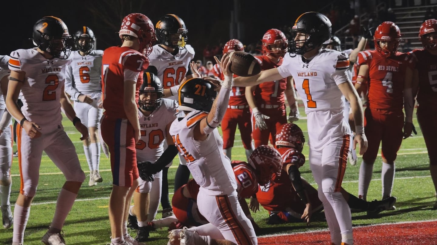 Luke DiPietro-Froio (1) joins a touchdown celebration during Wayland's 48-44 win at at Burlington Friday night.