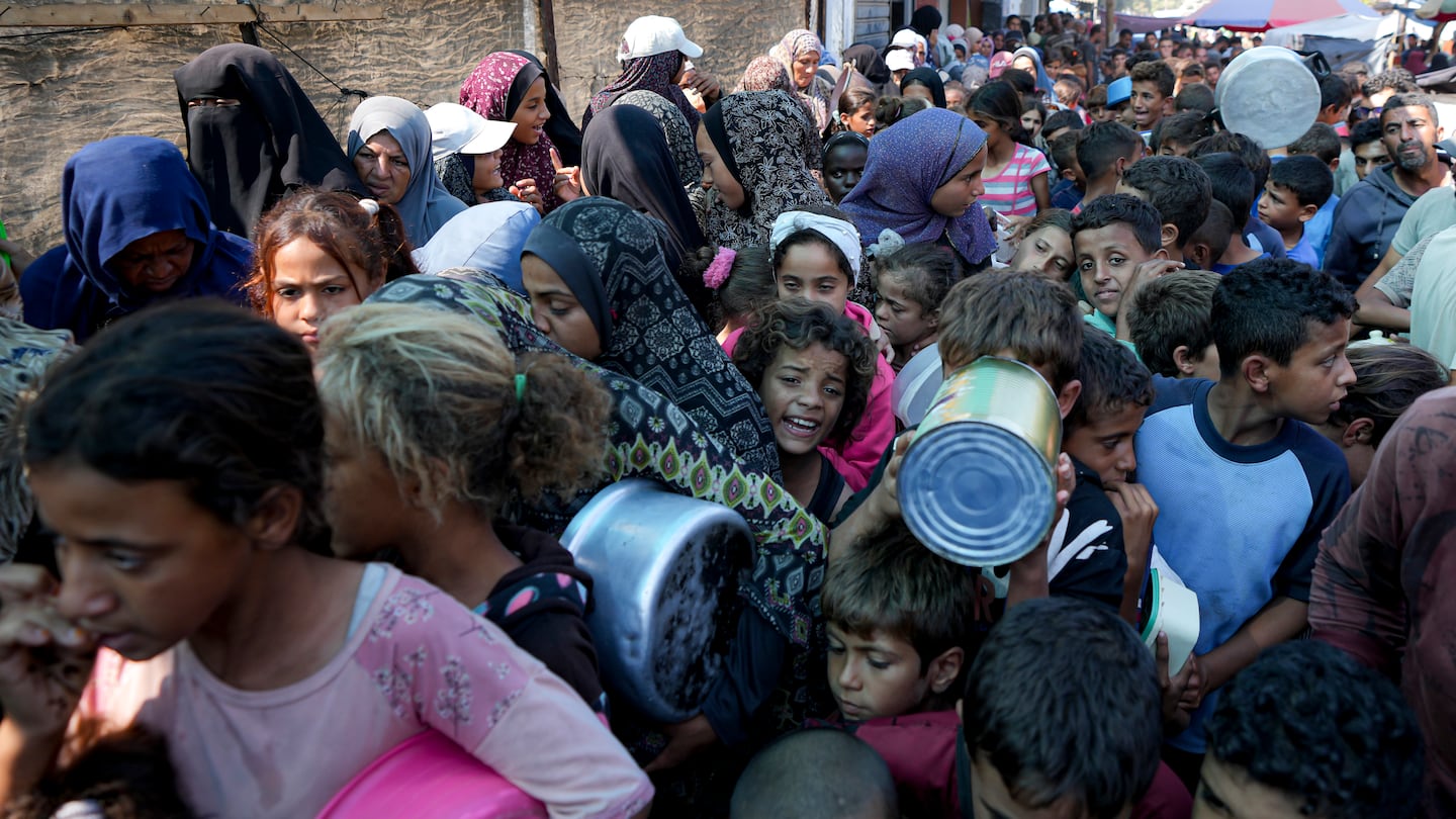 Palestinians line up for food distribution in Deir al-Balah, Gaza Strip, on Oct. 17.