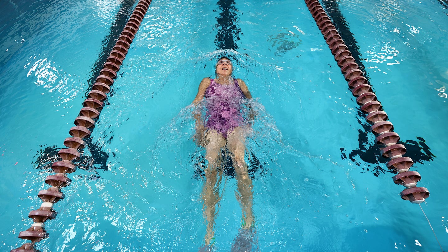 Betsy Lambert, who has long COVID, swims in a Northbridge pool.