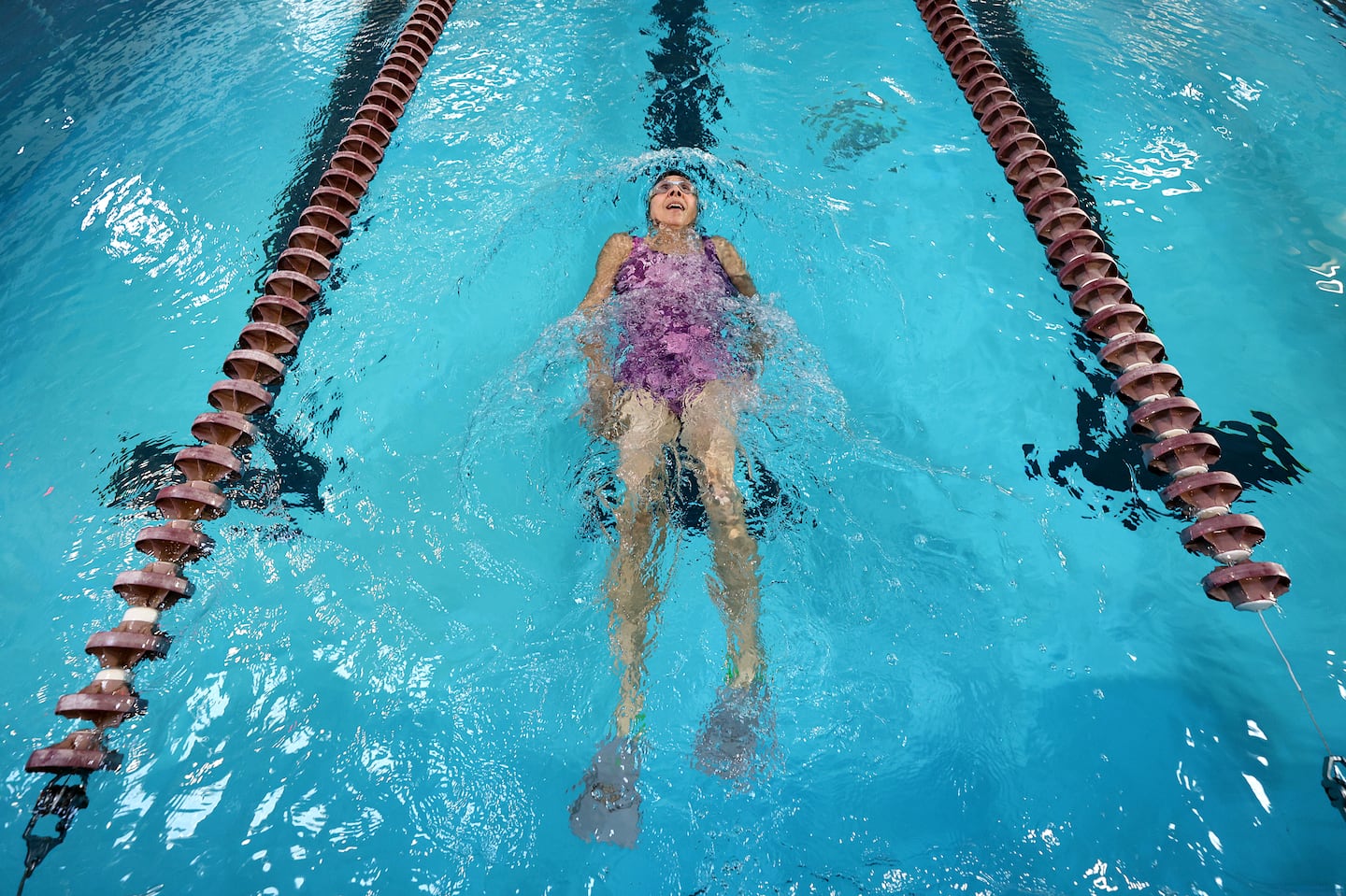 Betsy Lambert, who has long COVID, swims in a Northbridge pool.