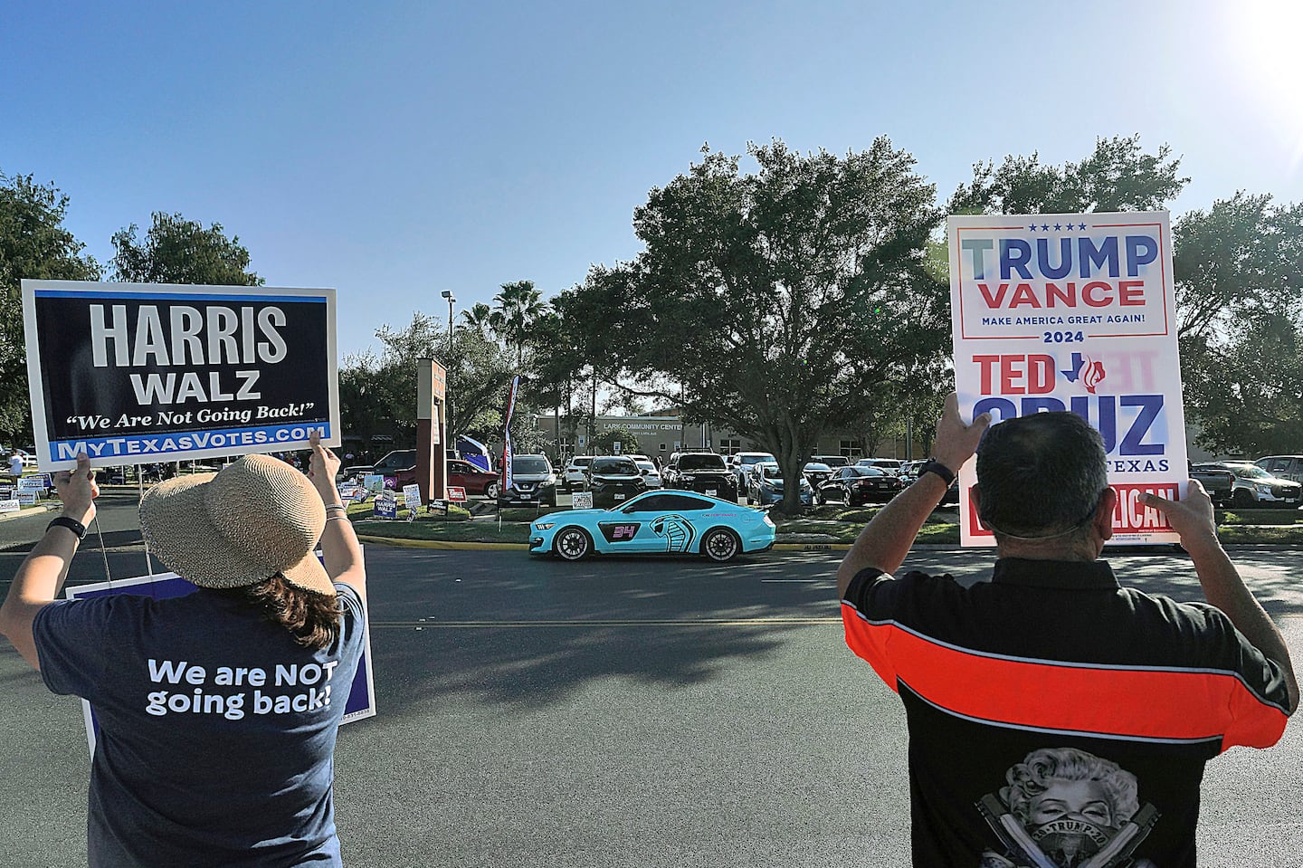 Supporters of Kamala Harris and Donald Trump campaign outside a polling place in McAllen, Texas, on Nov. 5.