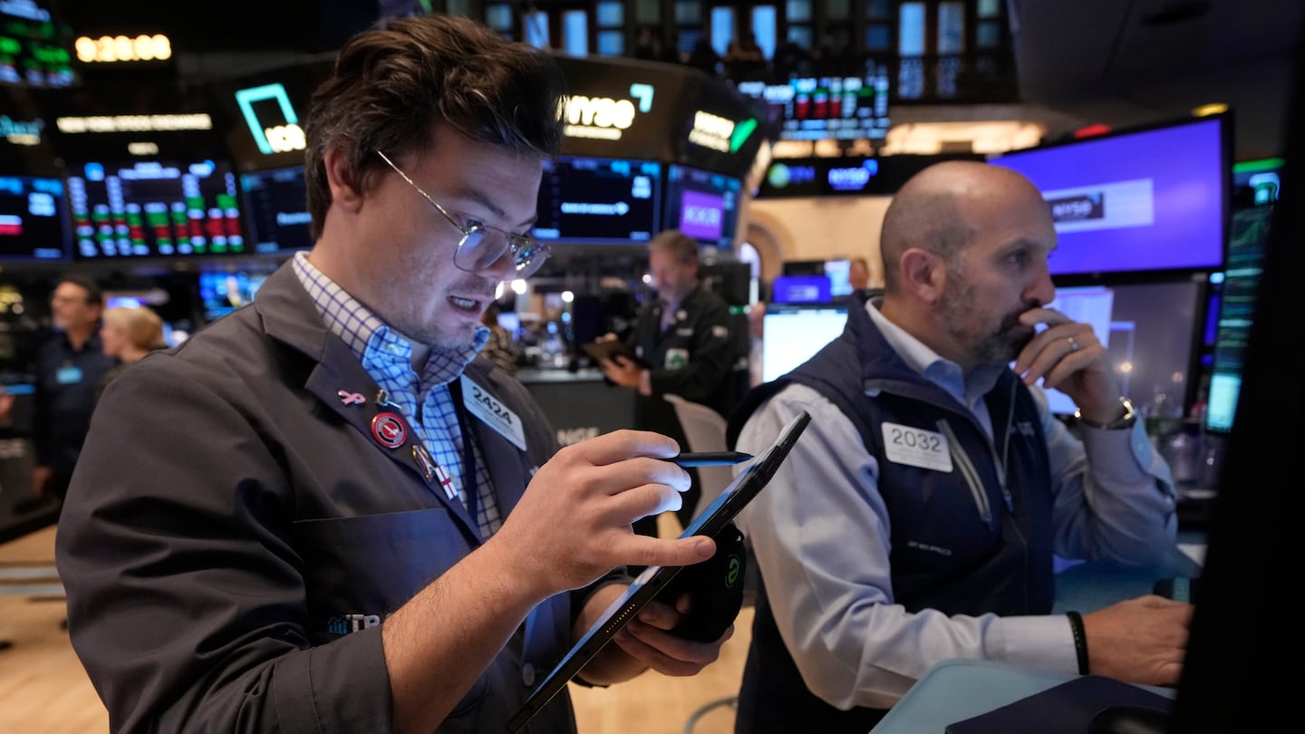 Trader William Lovesick, left, and specialist James Denaro work on the floor of the New York Stock Exchange, Friday, Nov. 8, 2024.