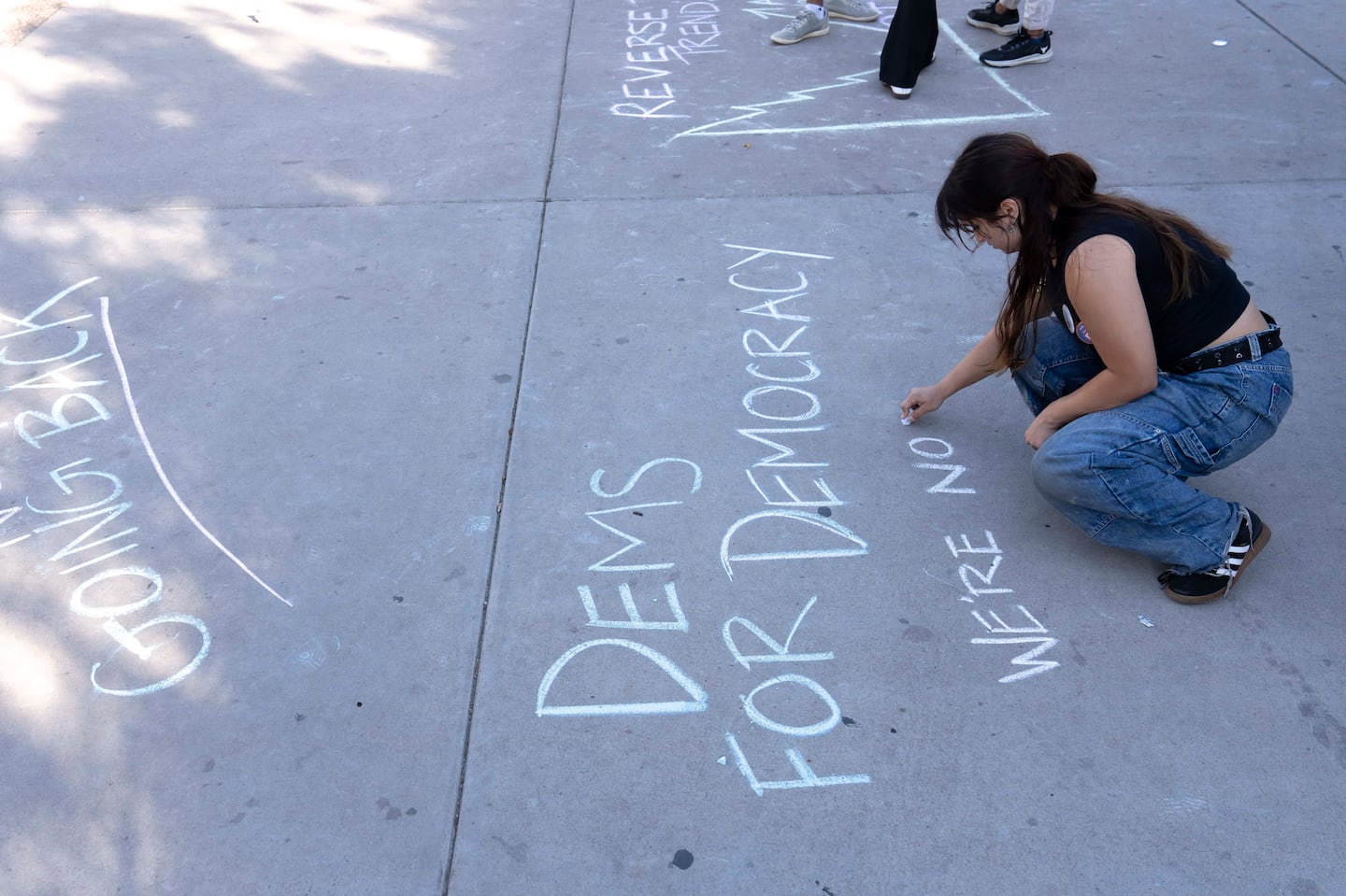 A Harris supporter wrote "Dems for democracy — we're not going back" at the Arizona State University polling location on Election Day.