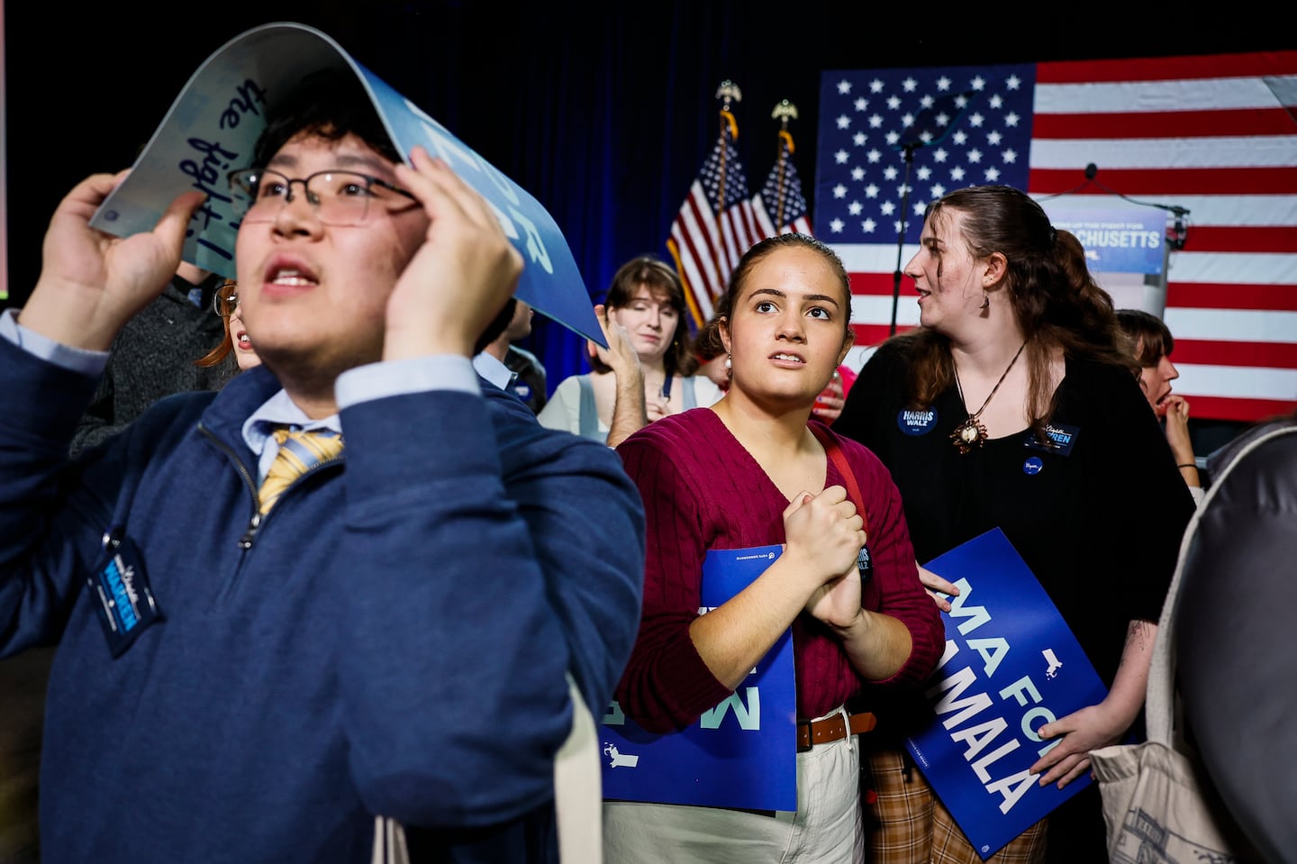 Arden Ferrari-Henry, center, a Suffolk University Student, watches the election results before the start of the an Election Night Watch Party hosted by the Massachusetts Democratic party at SoWa Power Station.