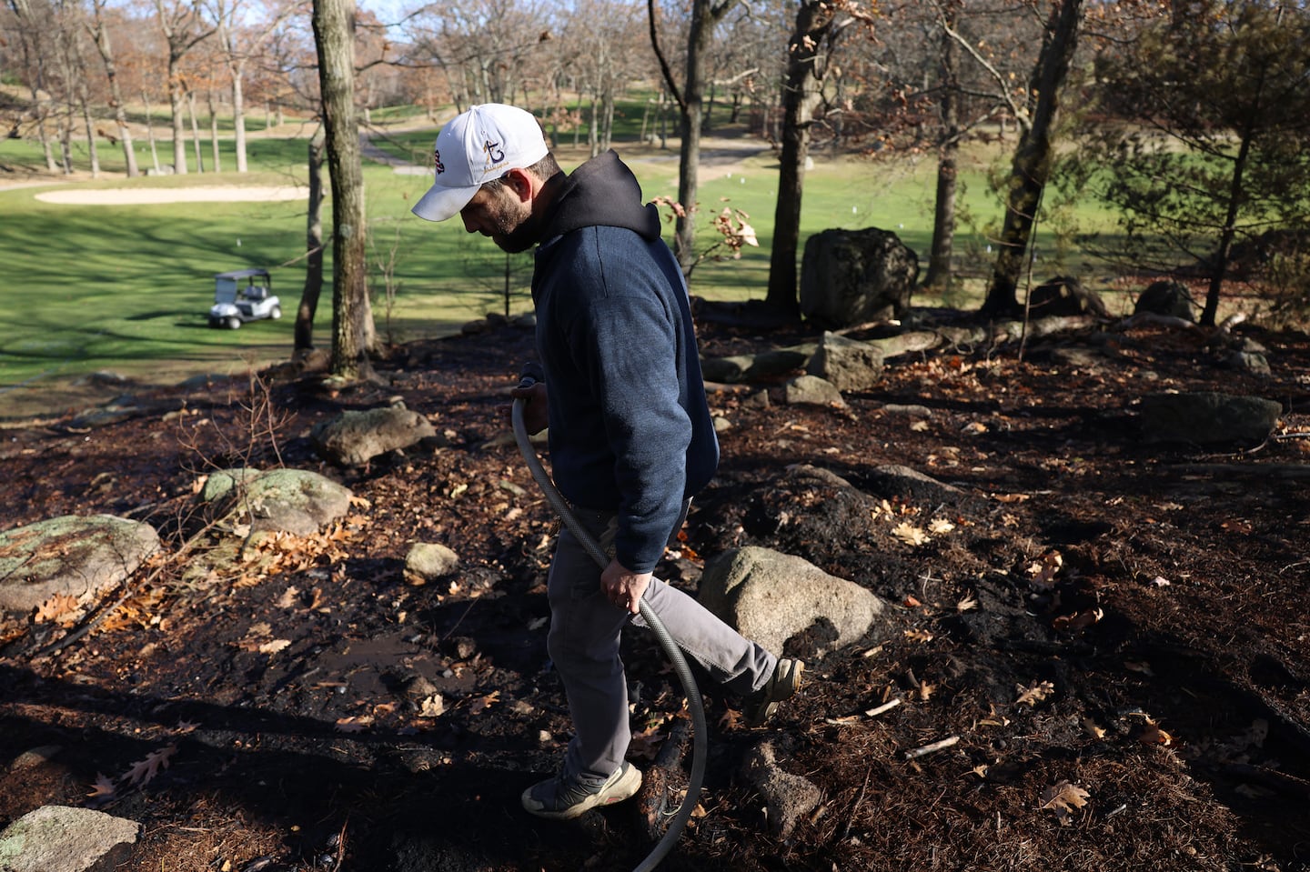 Kyle Levesque, superintendent at Gannon Golf Club in Lynn, used a hose to put out a hotspot that was encroaching on the golf course Tuesday.