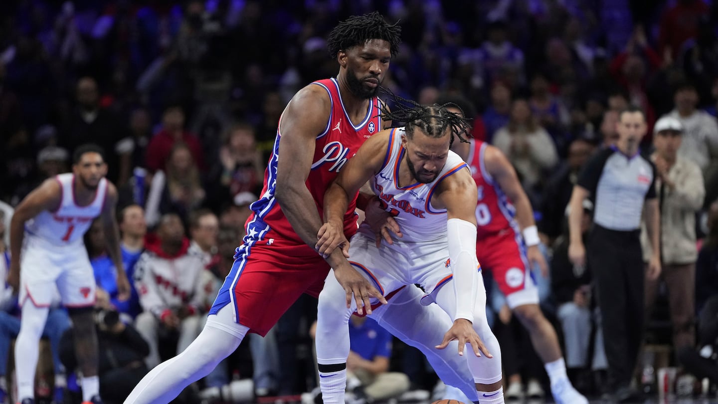 Knicks star Jalen Brunson (right) tries to fight off 76ers center Joel Embiid during the second half of Tuesday's NBA Cup opener for both teams in Philadelphia. 