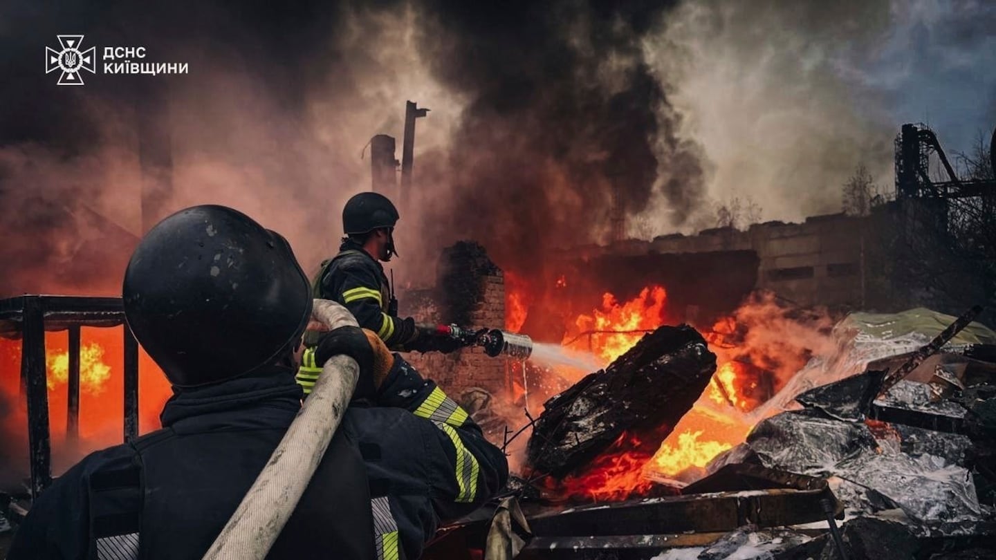 In this photo provided by the Ukrainian Emergency Service on Nov. 13, 2024, Rescue workers put out a fire of a building which was destroyed by a Russian strike in Brovary, outside Kyiv, Ukraine.