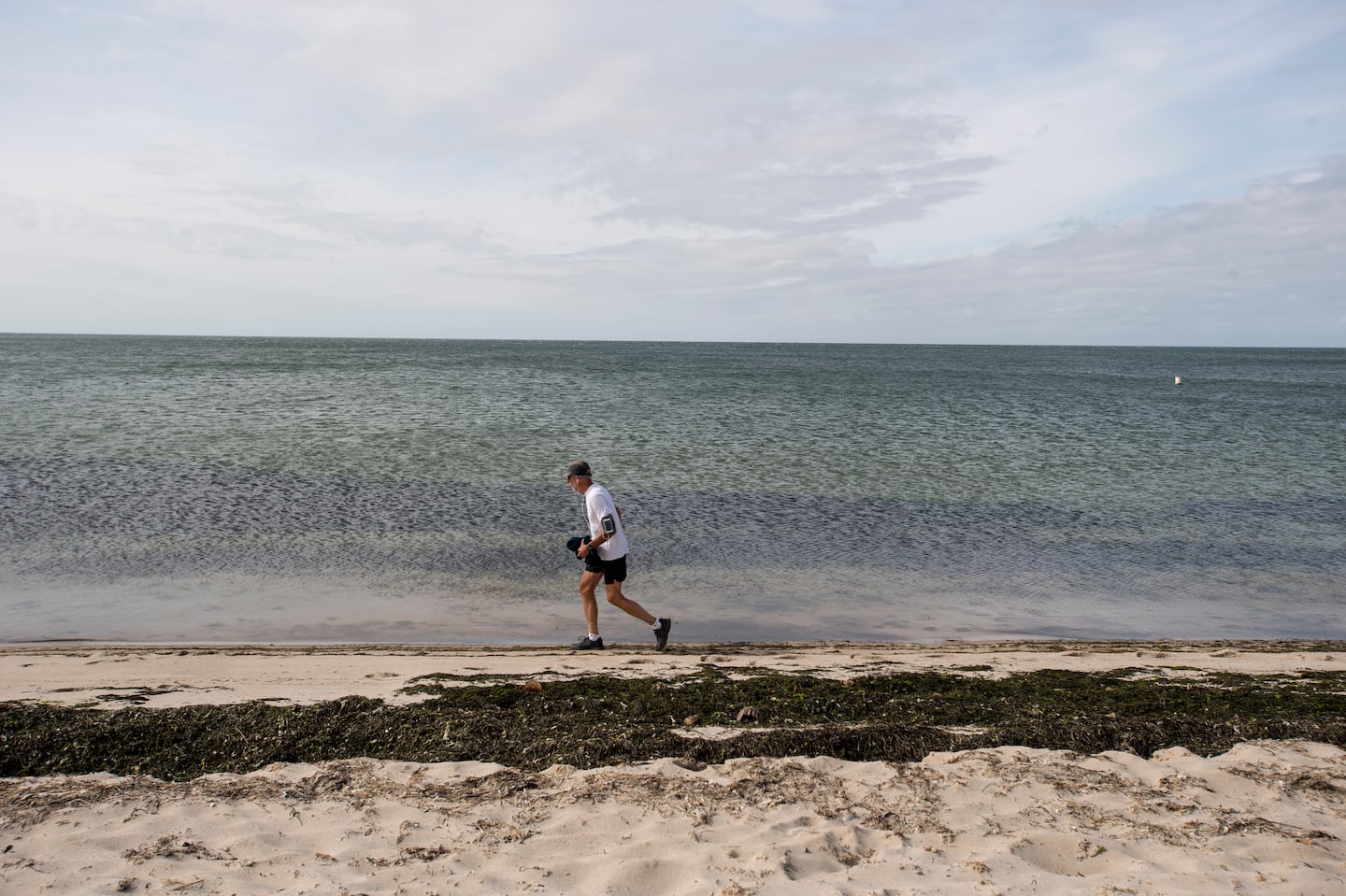 A runner on Cape Cod in September 2023. According to a new report, Massachusetts’ marine ecosystems will face a hotter, harsher future as climate change warms ocean temperatures.