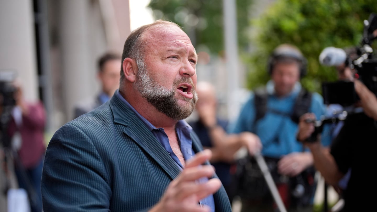 Right-wing conspiracy theorist Alex Jones speaks to the media after arriving at the federal courthouse for a hearing in front of a bankruptcy judge on June 14 in Houston.