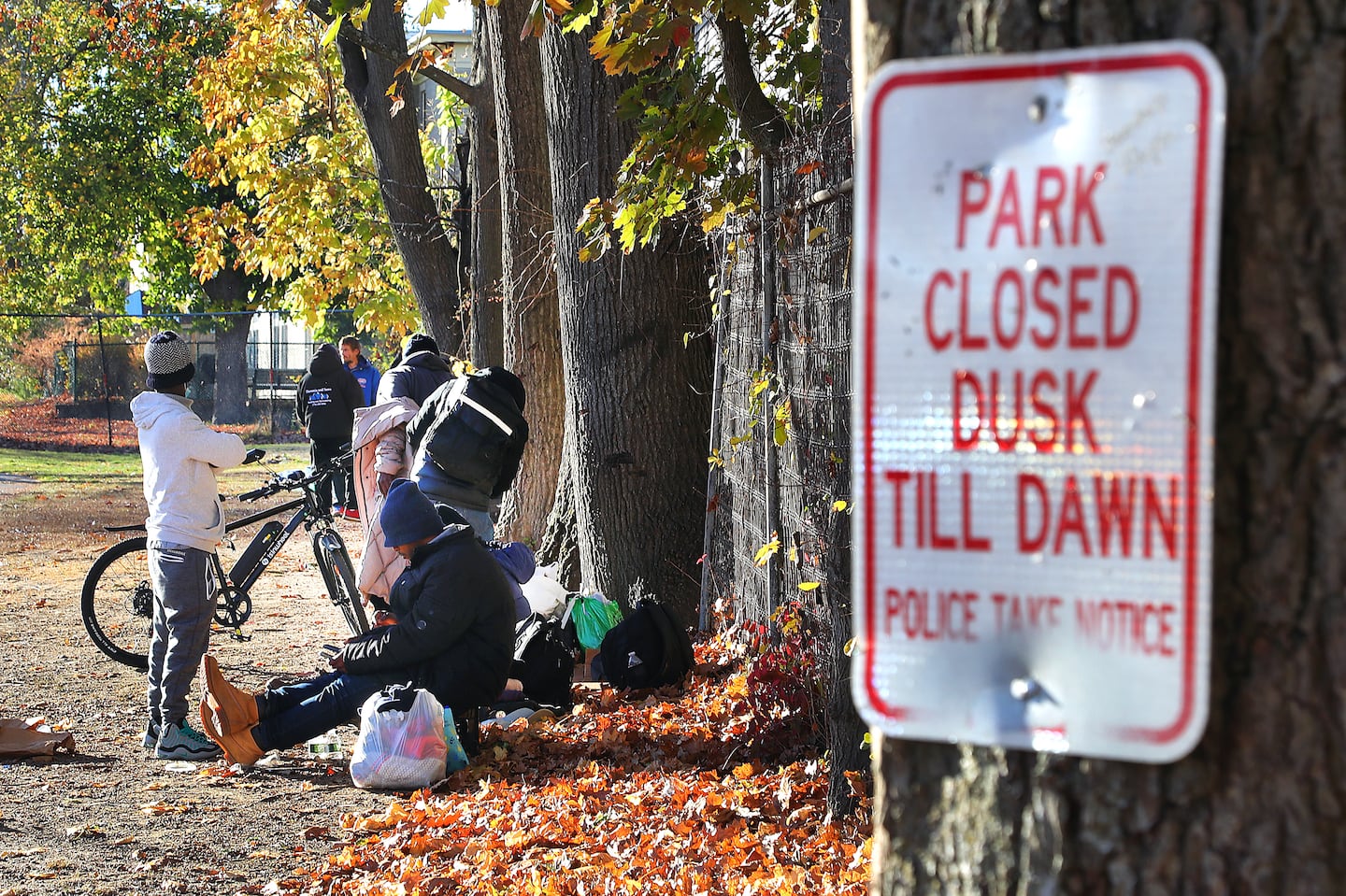 Homeless people sat in Perkins Park on North Main Street, a popular location for people to set up encampments.