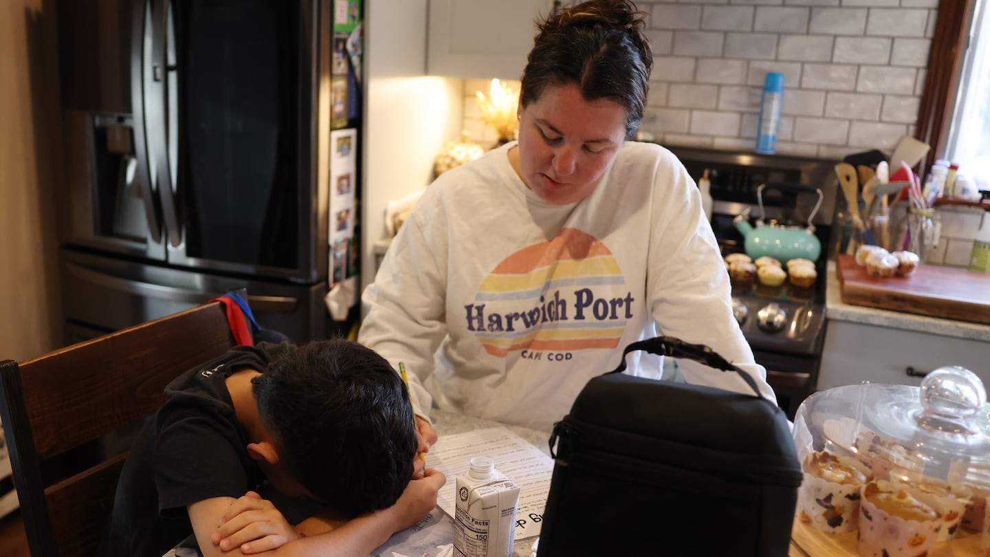 Jonathan Pagan put his head down as his mom, Jenni, wrote in the answers he gave her as they worked to complete a worksheet that asked him questions about his reading level and interests. Pagan is entering the fourth grade and only recently learned his letters despite being in a specialized district program.