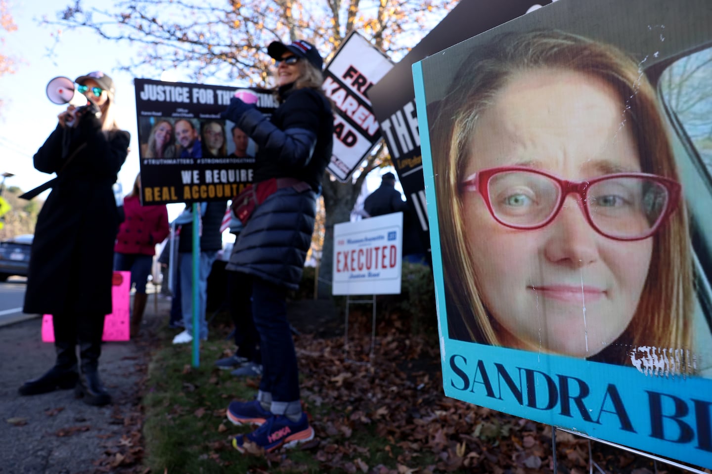 A photo of Sandra Birchmore was seen on a banner during a Stronger Together Standout where the groups Free Karen Read, Justice for Sandra Birchmore & Justice for Juston Root protested together outside of the Norfolk District Attorney's office.