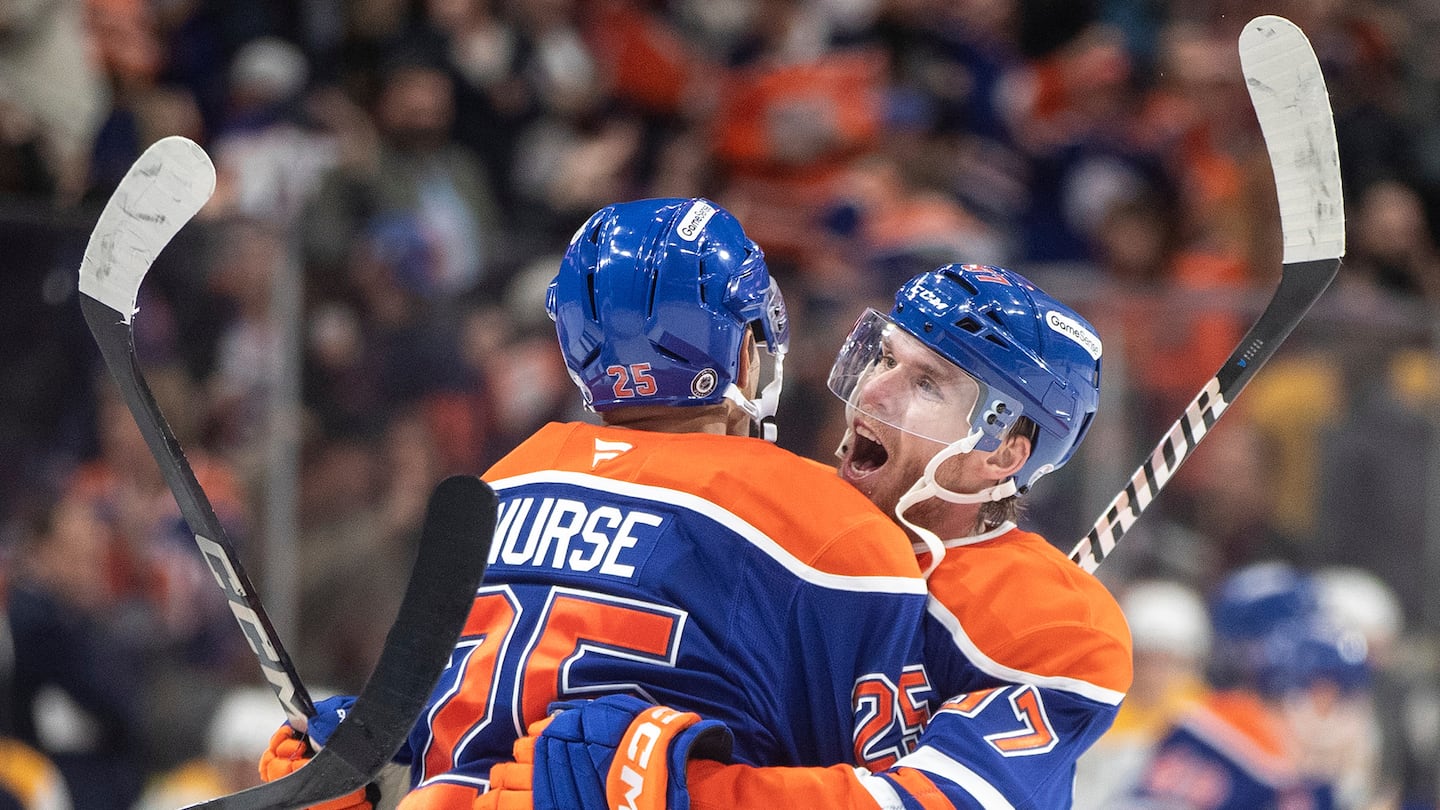 Connor McDavid celebrated his 1,000th point with teammate Darnell Nurse.