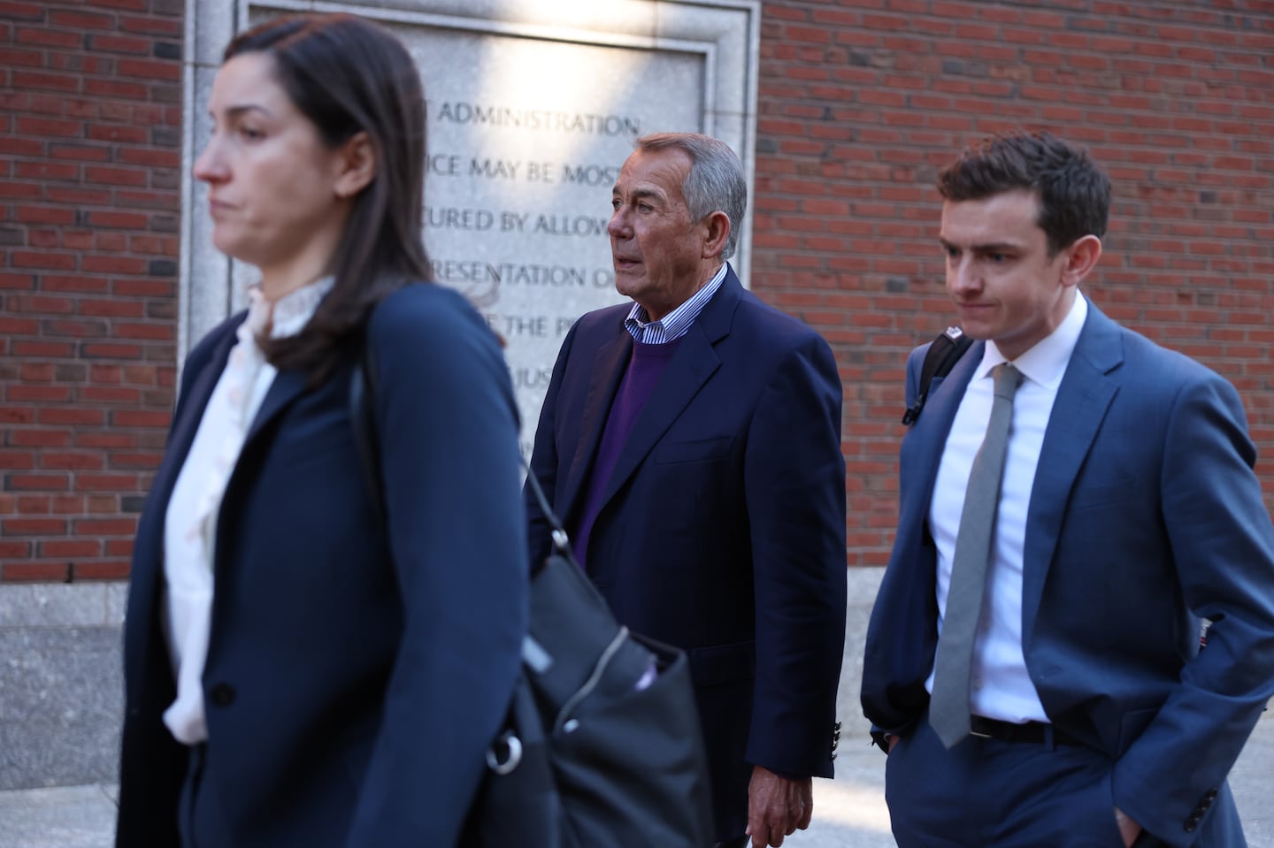 Former House speaker John Boehner (center) left federal court in Boston on Thursday morning.