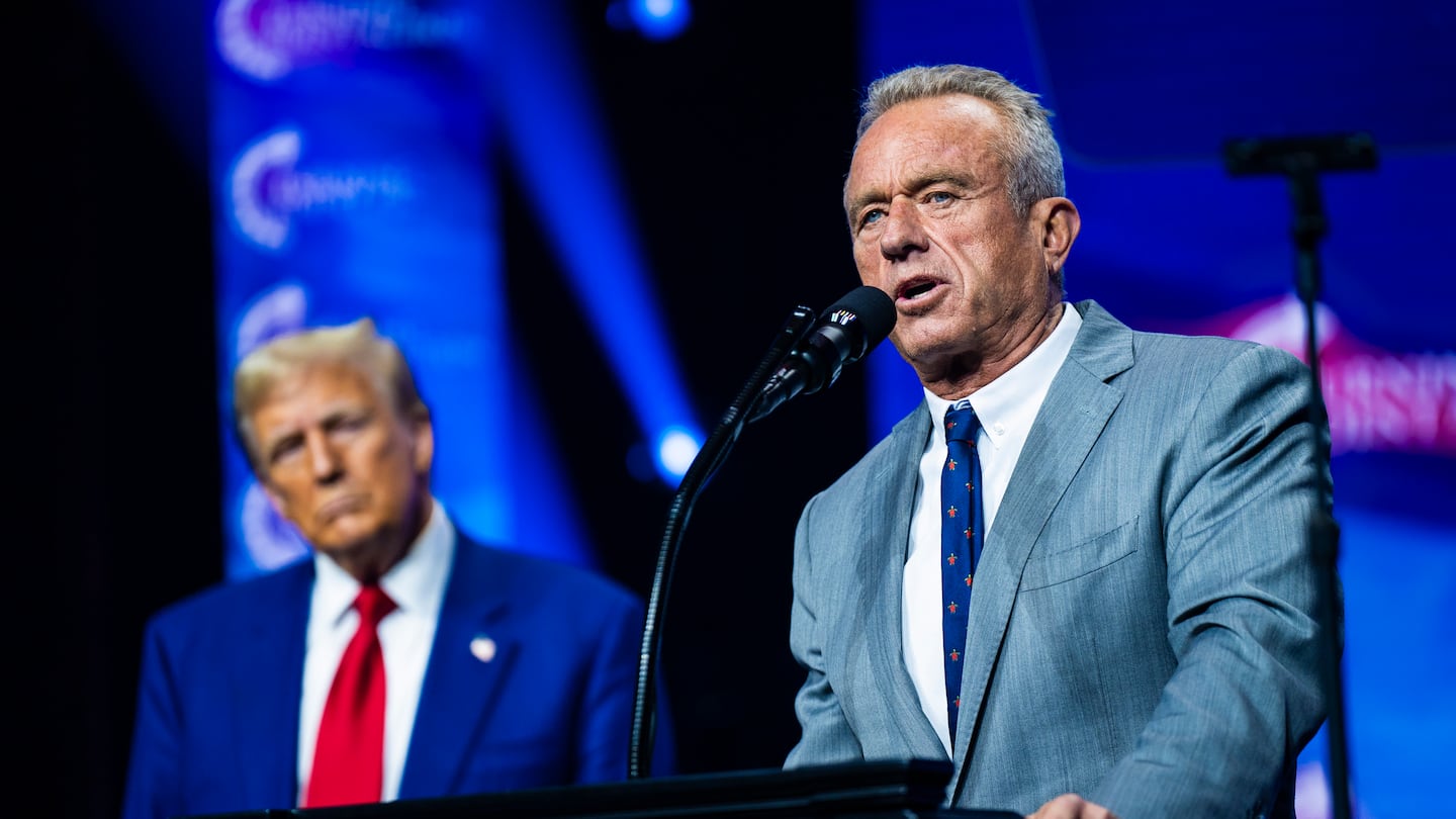 Robert F. Kennedy Jr. speaks with then-Republican presidential nominee Donald Trump at a Turning Point Action rally in Duluth, Georgia, on Oct. 23.