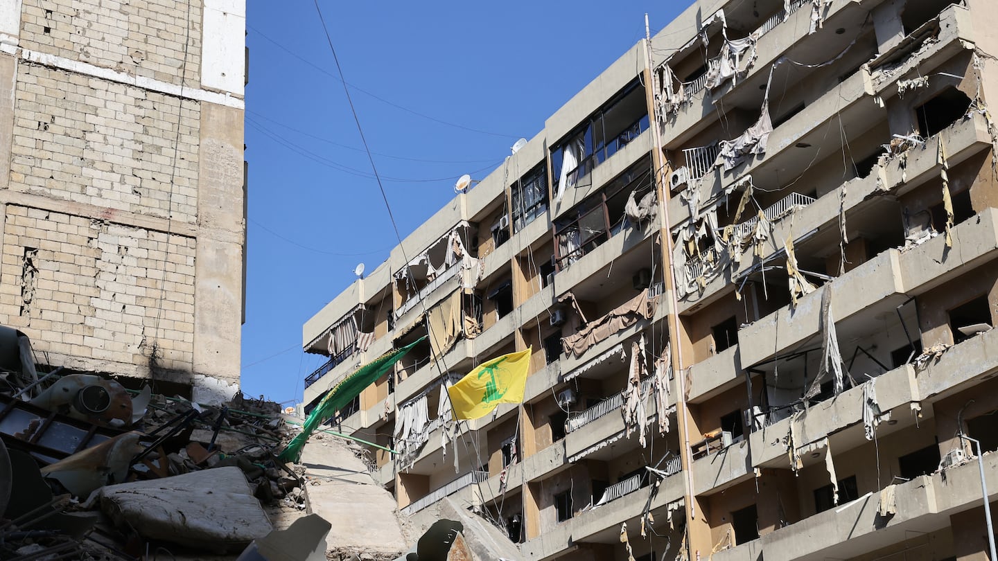 A Hezbollah flag flutters on one of the balconies of a building targeted by recent Israeli strikes in southern Beirut's Ruweiss district on Nov. 11, 2024, as the war continues between Israel and the Lebanese militant group.