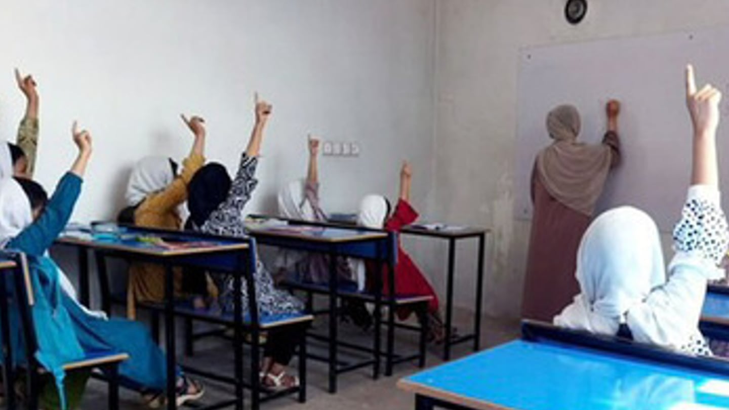 Students raise their hands at a school for girls in Afghanistan formed by Khadija Nazari, who escaped Kabul just as the Taliban gained control and who now studies at Brown University in Providence, R.I.