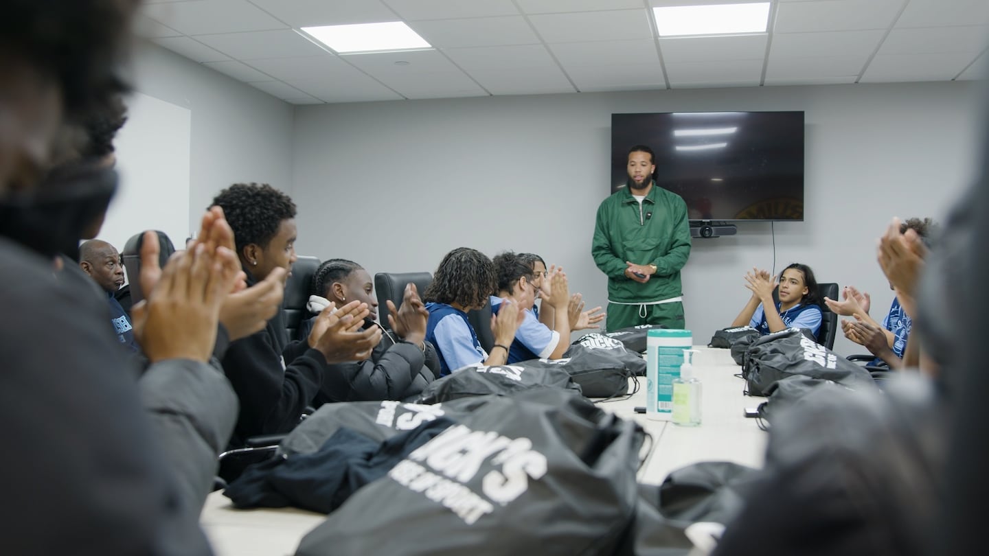 Michael Carter-Williams talking to the basketball teams from English High School and Charlestown High School at the final session of a mental health and mindfulness workshop series.