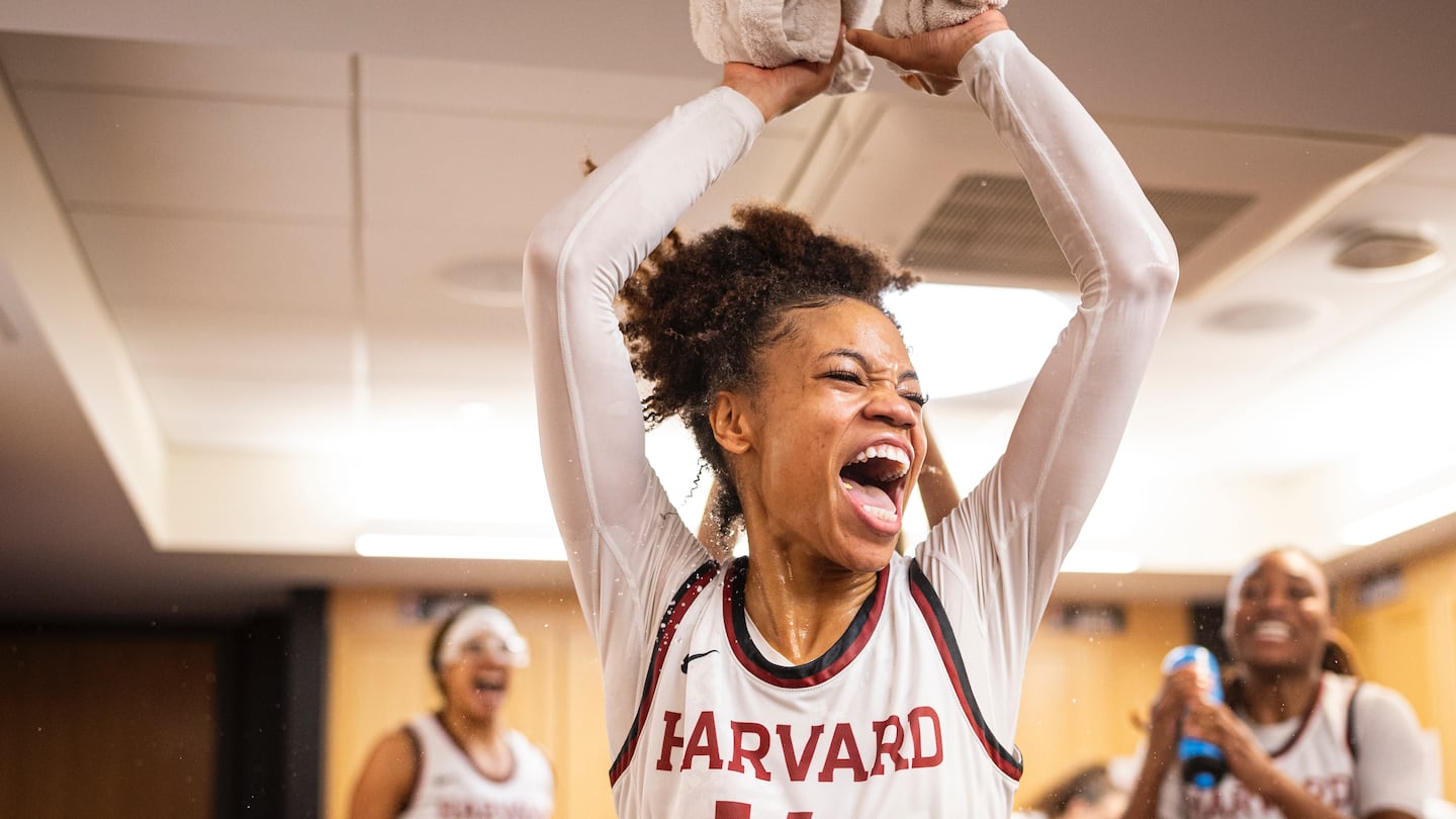 Harmoni Turner celebrates in the locker room after Harvard's win over Boston College.