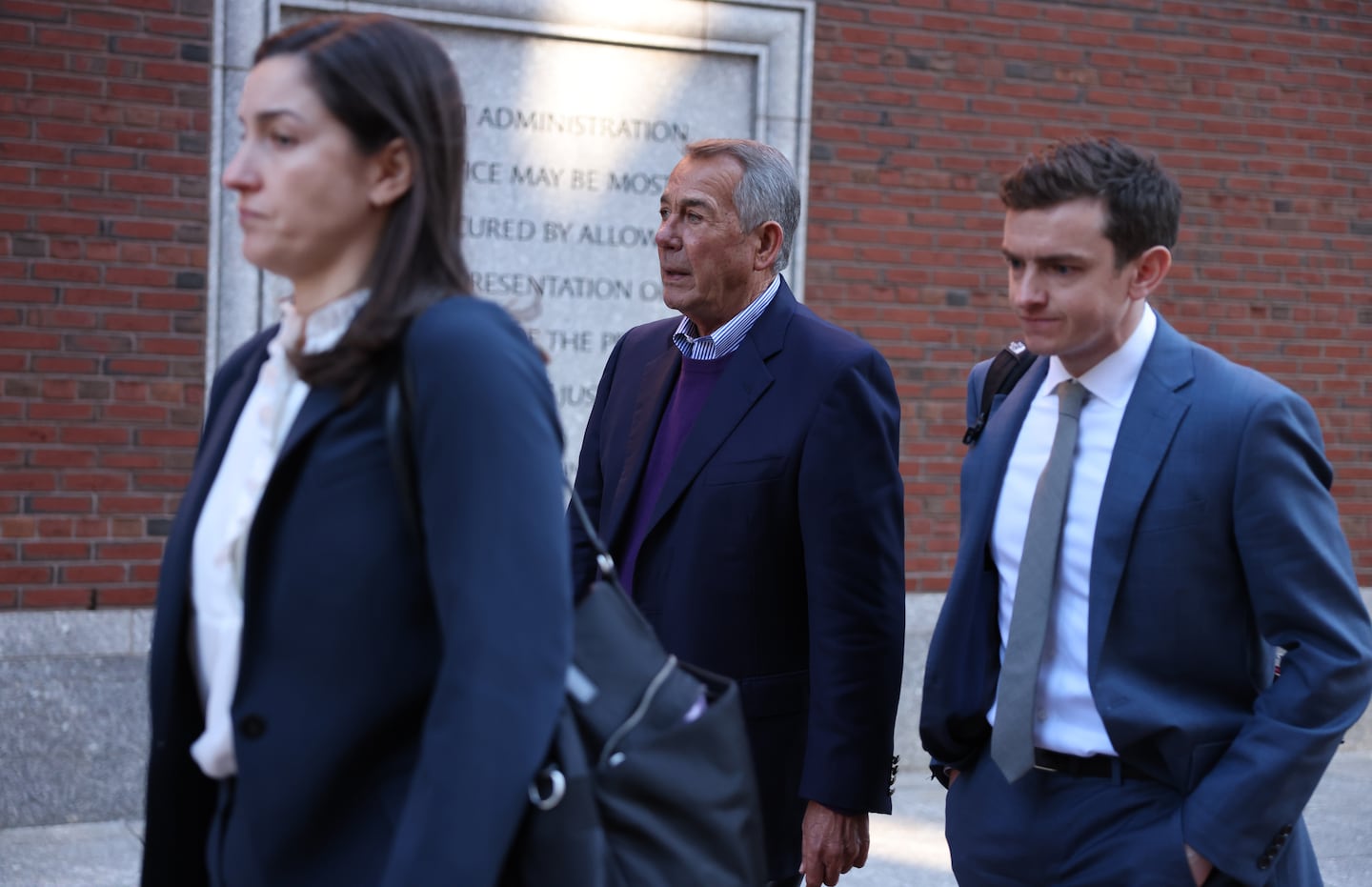 Former House speaker John Boehner (center) left federal court in Boston on Thursday morning.