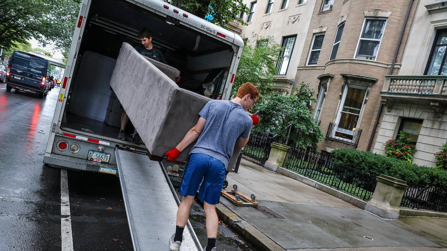 Kyle Needs (left) and Trevor Callahan carried a couch out of a van while helping a friend move in Boston in 2021.