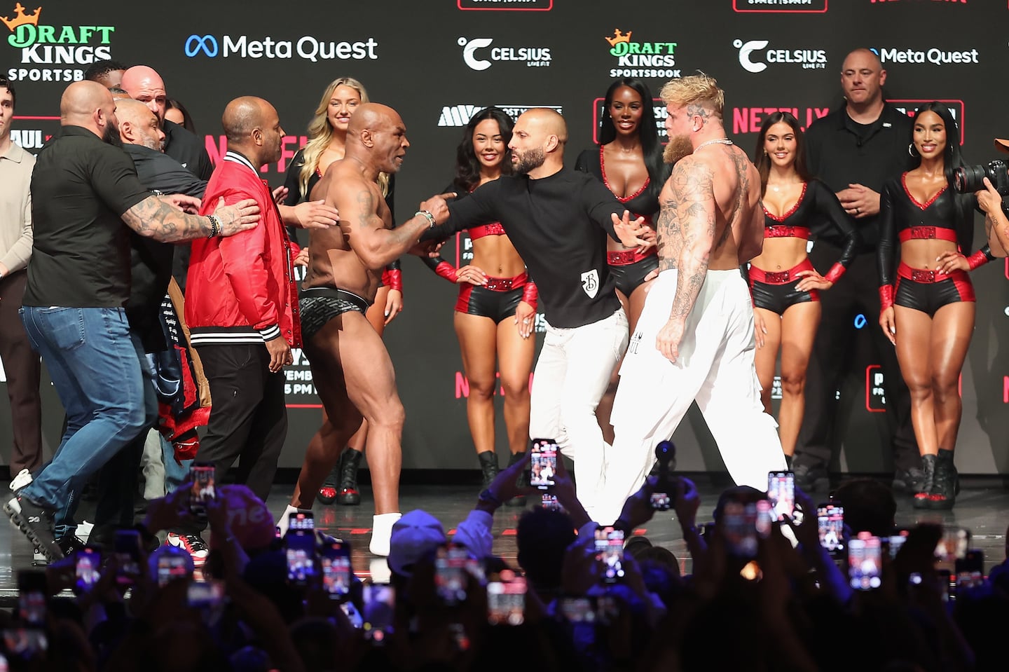 Mike Tyson and Jake Paul are separated as they face off during their ceremonial weigh-in at The Pavilion at Toyota Music Factory on November 14, 2024 in Irving, Texas.