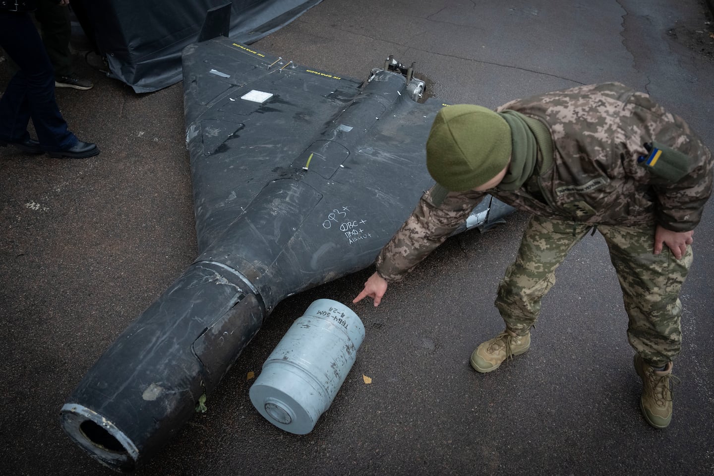 A Ukrainian officer shows a thermobaric charge of a downed Shahed drone launched by Russia in a research laboratory in an undisclosed location in Ukraine, on Nov. 14.