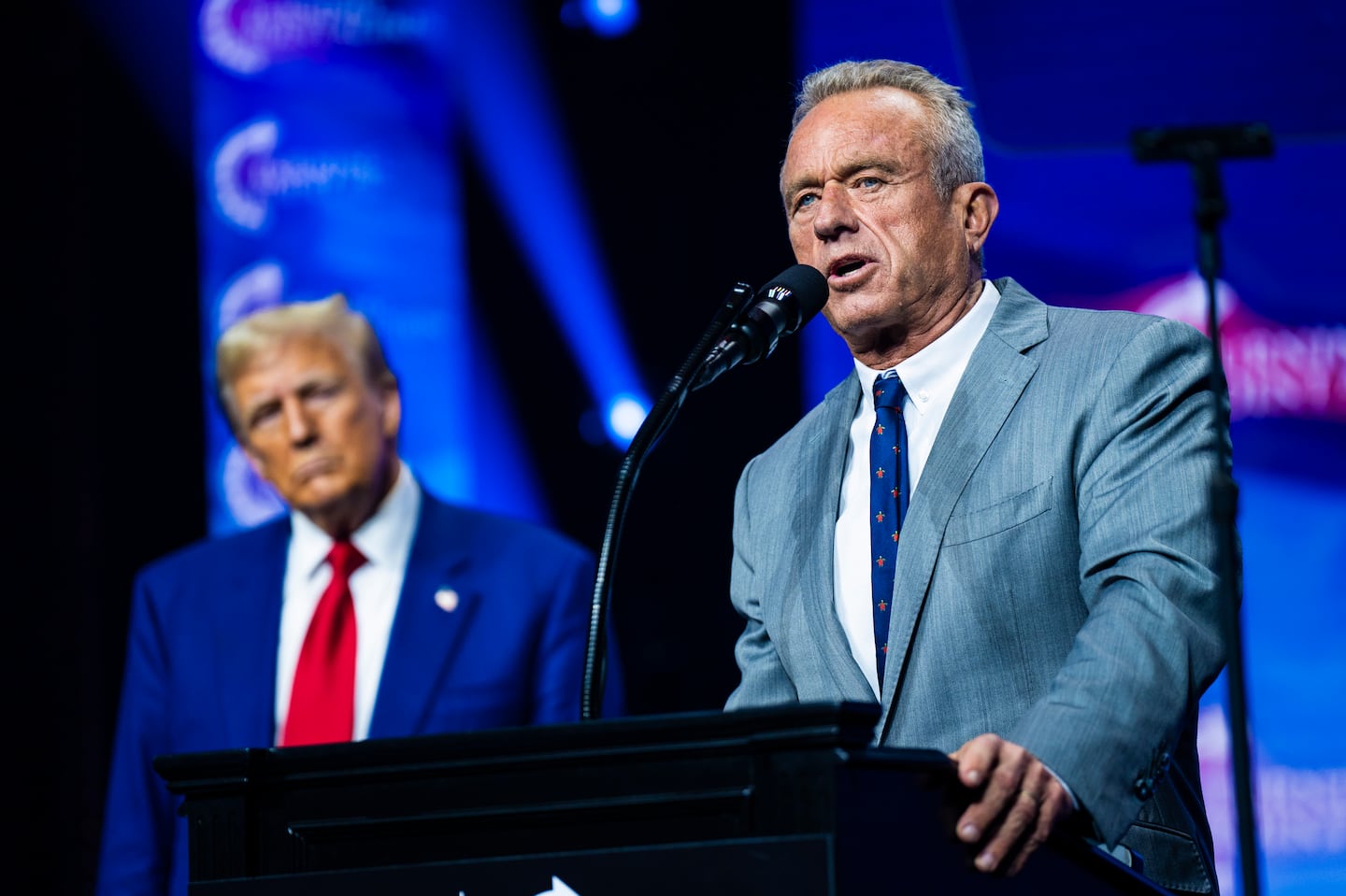 Robert F. Kennedy Jr. speaks with Donald Trump at a Turning Point Action rally in Duluth, Georgia, on Oct. 23.