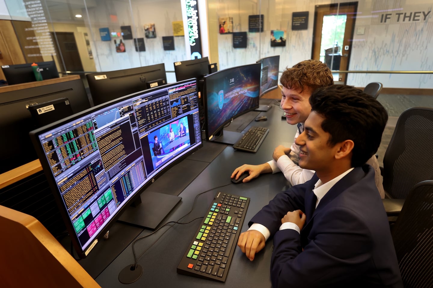 Sai Hejmadi (left) and Aidan Swenson, members of the Bentley Investment Group, in the school's trading room.