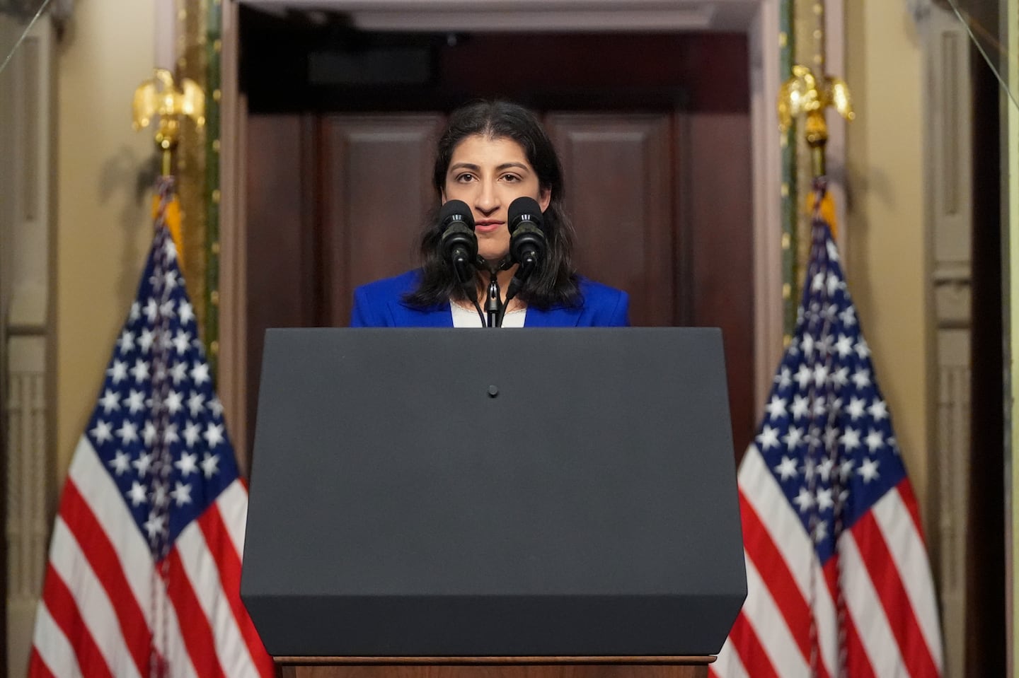 Lina Khan talks about health care costs at the Eisenhower Executive Office Building on the White House complex in Washington, on April 3.