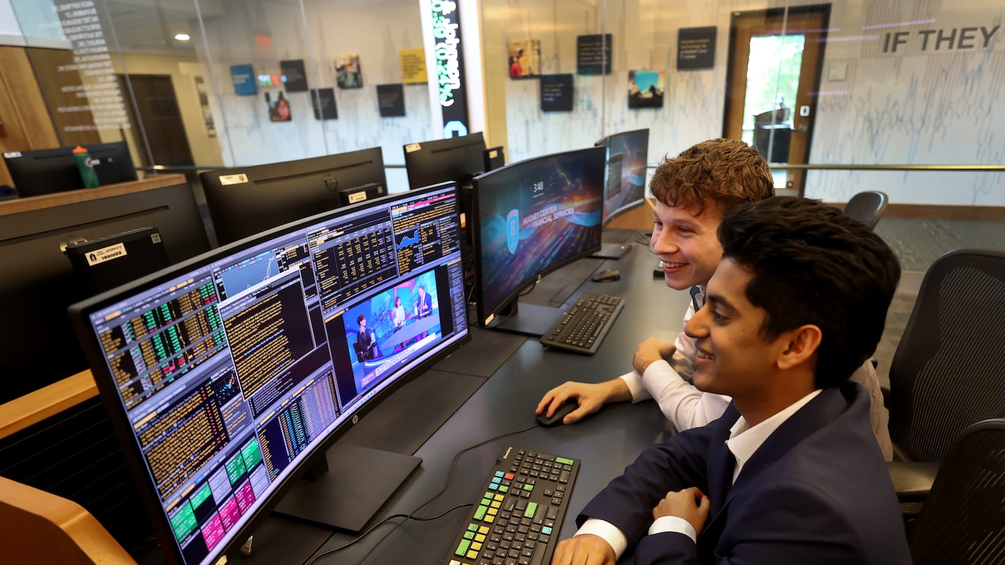 Sai Hejmadi (left) and Aidan Swenson, members of the Bentley Investment Group, in the school's trading room.