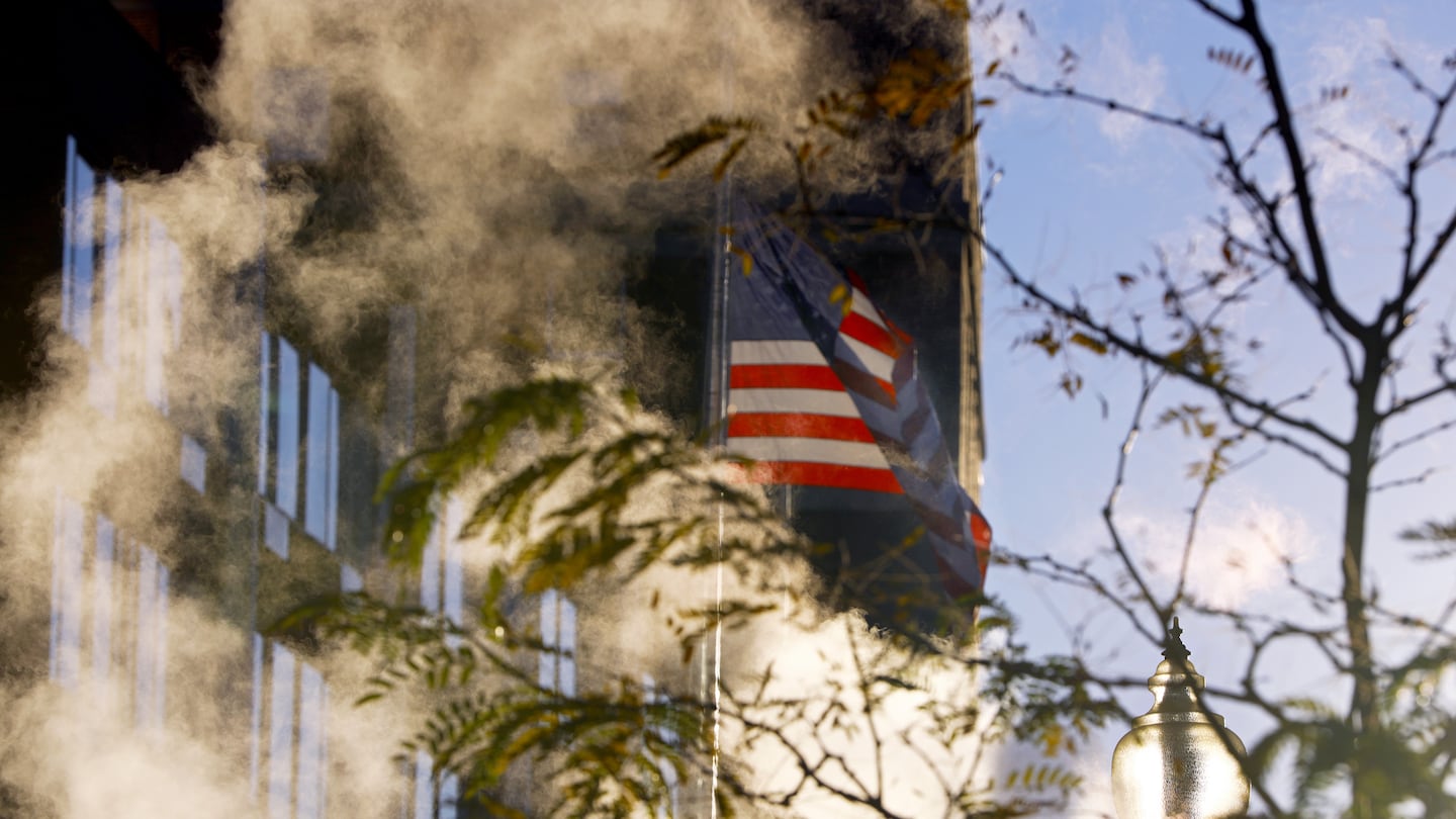 An American flag was backlit in the late-afternoon sun as steam rose from a vent on Harrison Avenue in Boston's South End.