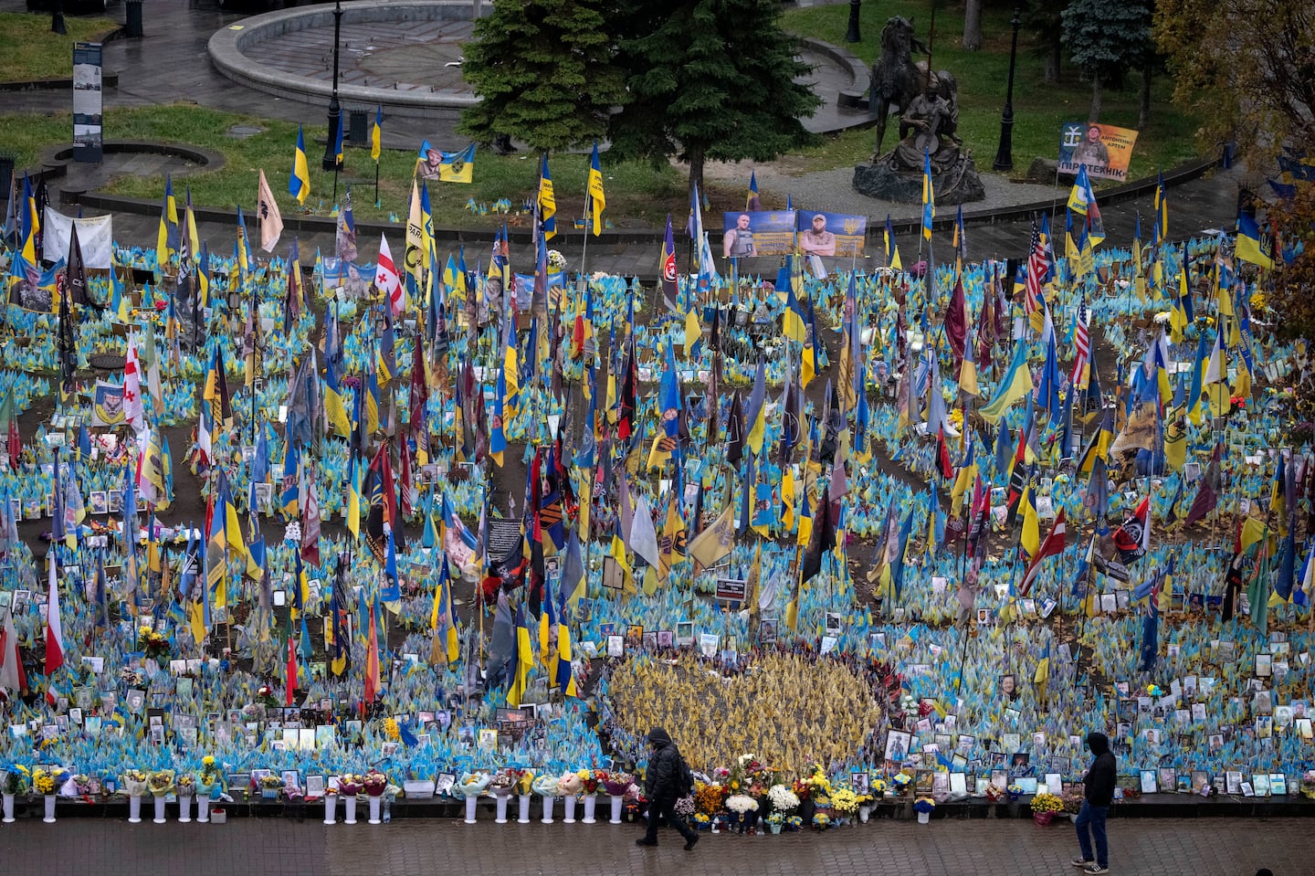 People walk past the memorial to fallen soldiers in Independence Square in Kyiv, Ukraine, on Nov. 15.