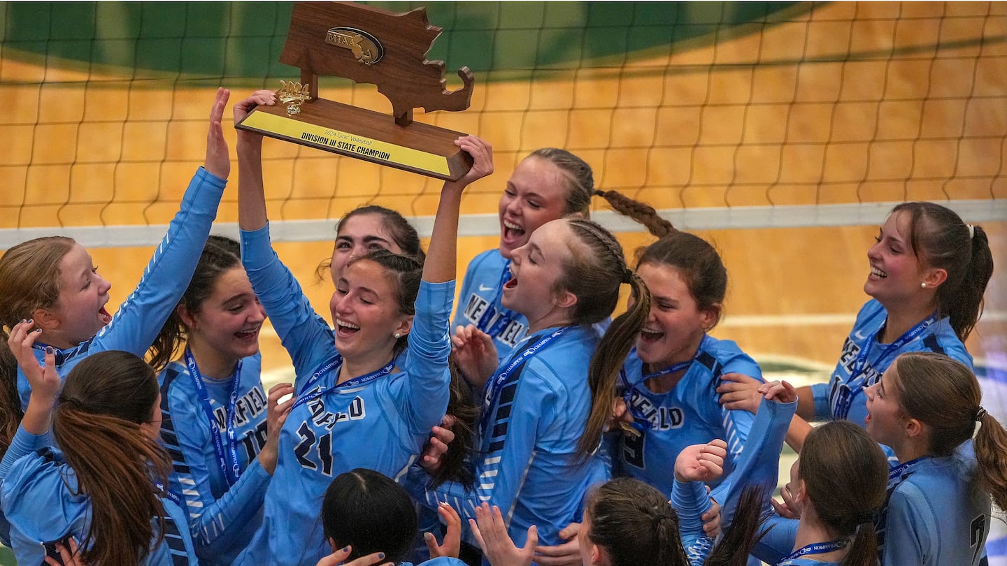 Kayla Hanna hoists the MIAA championship trophy after Medfield defeated Weston in the Division 3 final.