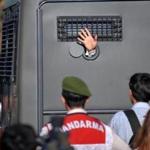 An Ergenekon prisoner waved at protestors as police and gendarmerie blocked access to a courthouse in Silivri, near Istanbul, where prosecutors are scheduled to deliver their final arguments in the case against people accused of plotting to overturn the Islamic-leaning government.