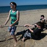 From left, Andrew Lawless, Morgan Yeager, Dan English, and Ghia Parow put their backs to a tug of war at Herring Cove Beach in Provincetown.