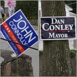 In West Roxbury, signs for Conley and Connolly compete. 
