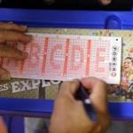 A Powerball lottery form was filled out Wednesday in San Antonio. Lottery officials said three grand-prize winners will split the $448 million jackpot.