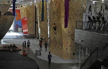 Once a place for serious rock climbers during the winter, rock gyms are appealing to a broader audience.
