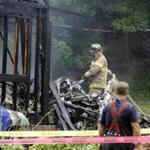 Firefighters work at the scene of a small plane crash, Friday, Aug. 9, 2013, in East Haven, Conn.