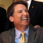 The move by Republican Governor Pat McCrory (seated) is expected to touch off a major court battle over voting rights.
