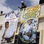 Relatives of Mustafa al-Haj put up banners in the village of Brukin, south of Nablus in the West Bank, depicting the Palestinian who killed a hiker in 1989.