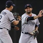 Shane Victorino (winning two-run single in the 11th) is congratulated at game’s end by Jacoby Ellsbury and Jonny Gomes.
