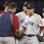 Boston Red Sox manager John Farrell (left) took the ball from starting pitcher Jake Peavy in the seventh inning.
